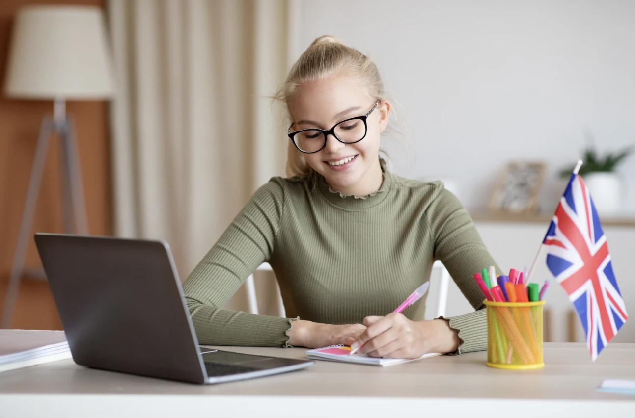 Blonde teen girl studying UK Flag